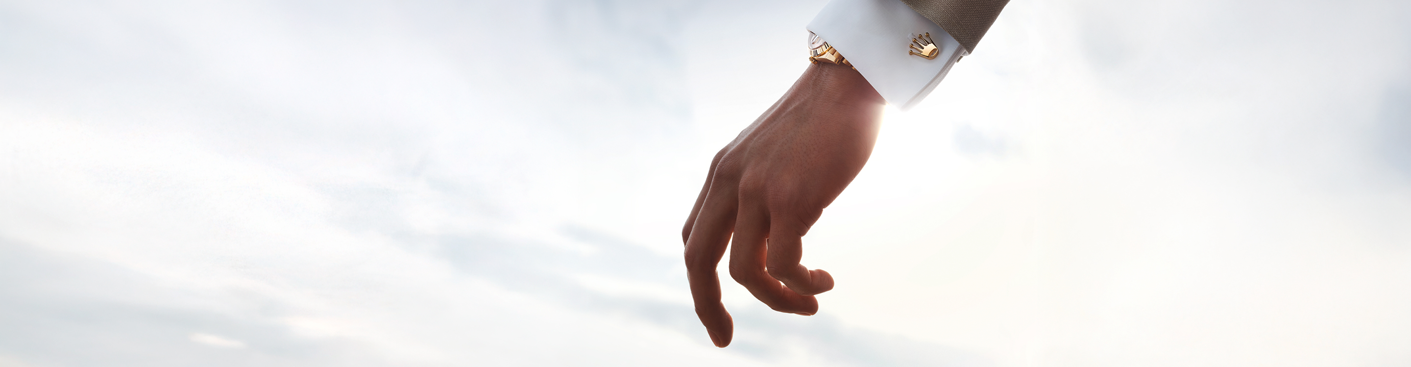 wrist with a Rolex cufflink