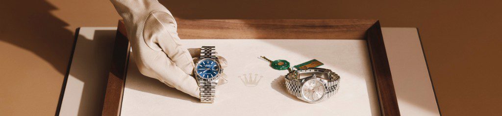 Rolex retailer presenting a watch