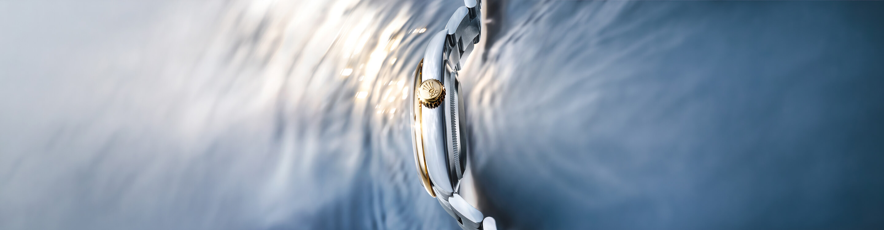 Rolex watch crown at the water's surface