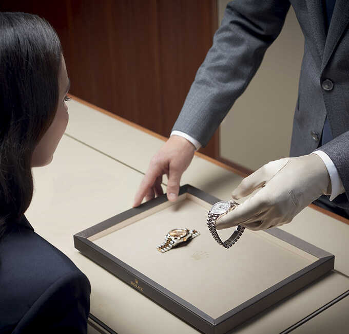A Rolex expert showing a customer a Rolex