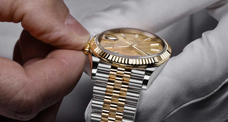Image of watch being delicately handled